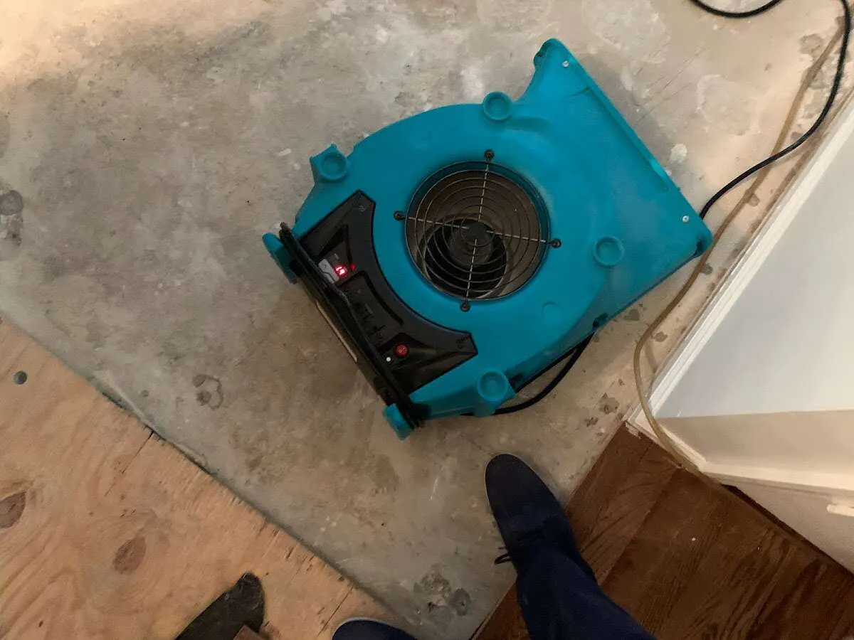 Air mover drying subfloor during Commercial Water Damage Restoration in Midlothian